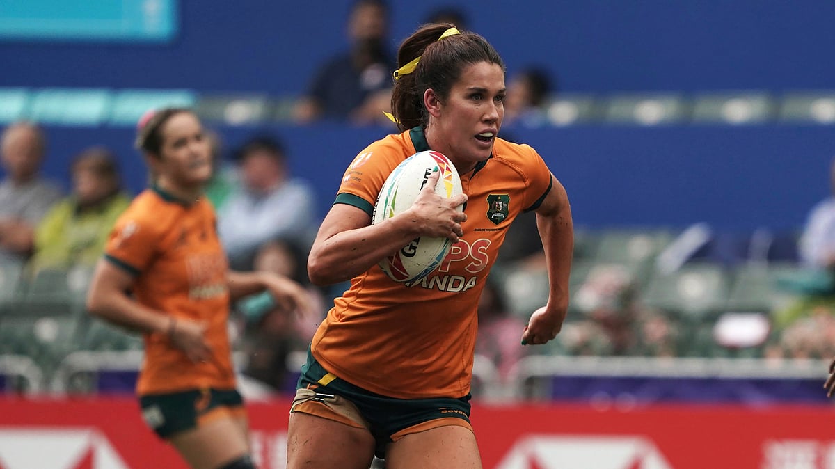  (AP Photo/Anthony Kwan, File)
 : FILE - Australia's Charlotte Caslick runs to score a try against Fiji during the second day of the Hong Kong Sevens rugby tournament in Hong Kong, Saturday, April 1, 2023. Caslick will lead Australia's world series champion squad to the Paris Olympics, where she's aiming to win her second gold medal after taking the honors when rugby sevens made its debut at the Summer Games in 2016.

